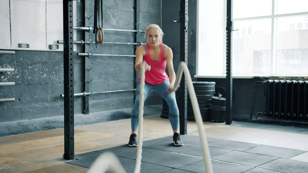 A close-up image of a black kettlebell on a wooden floor