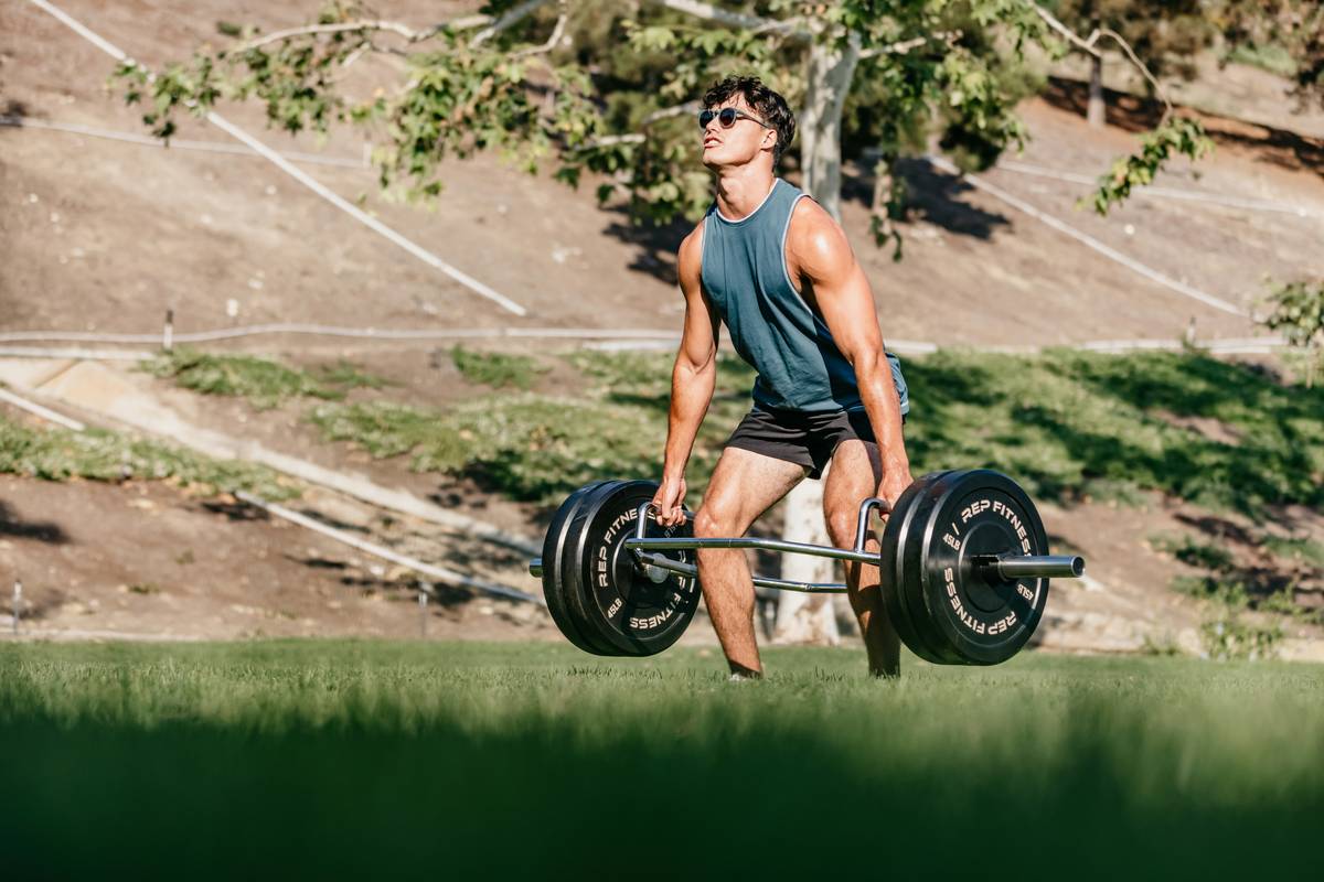 A person demonstrating correct kettlebell swing form, focusing on hip hinge and neutral spine.