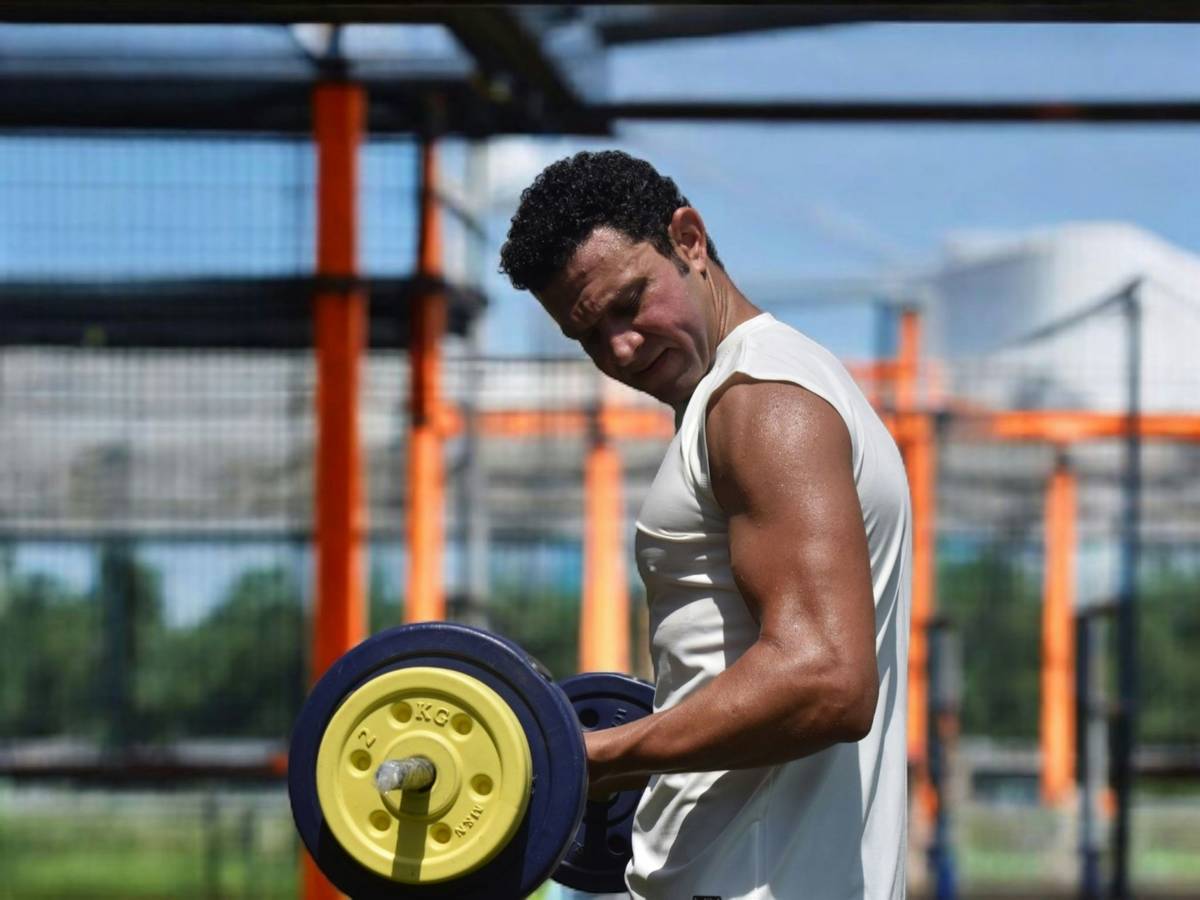 Man performing an intense kettlebell swing at the gym