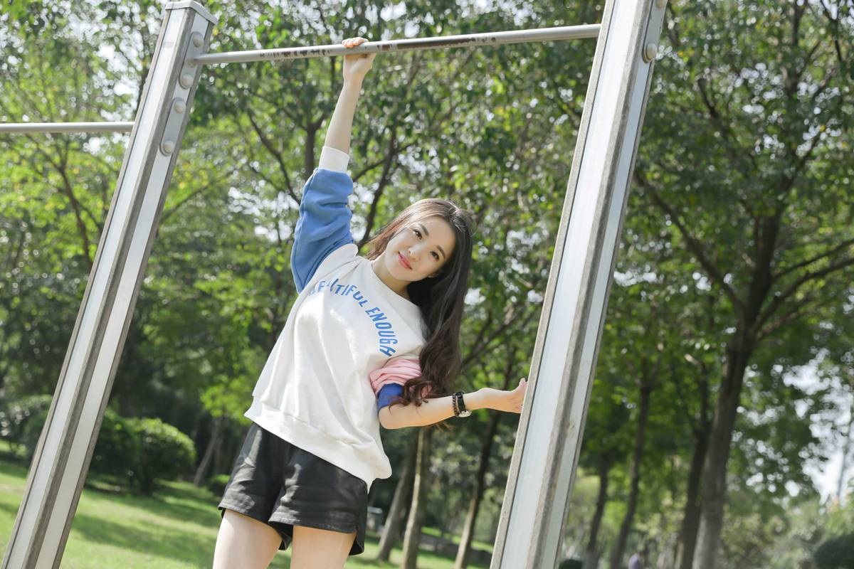 A person performing a kettlebell swing outdoors with proper form.